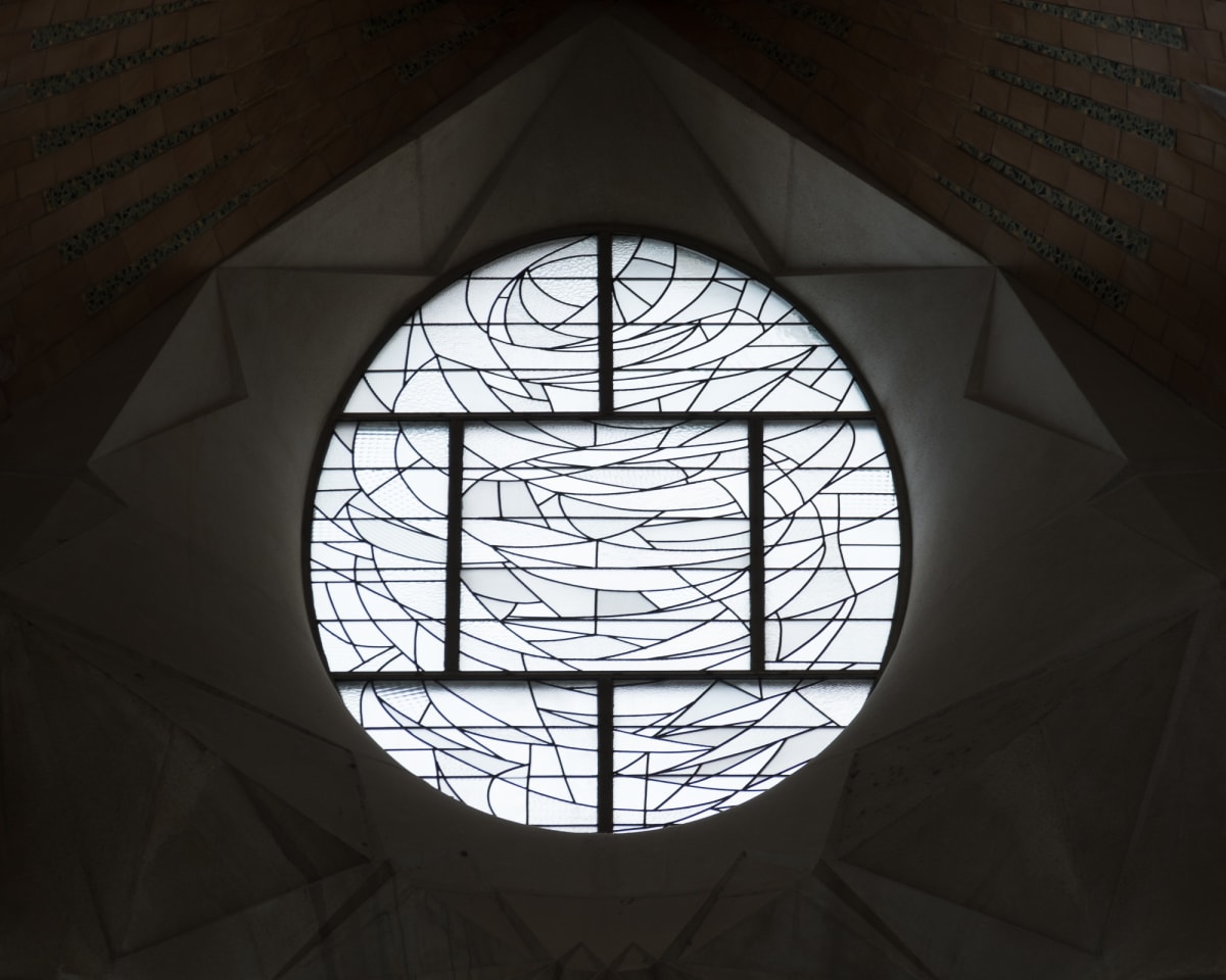A patterned glass window in la Sagrada Família. It looks similar to an abstract stained glass window, but with frosty white glass.