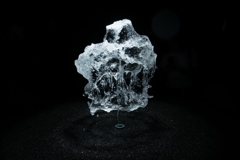 A round shower of water is frozen in mid air by strobe lighting.