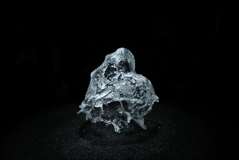 A round shower of water is frozen in mid air by strobe lighting.