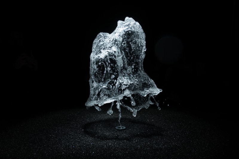 A round shower of water is frozen in mid air by strobe lighting.