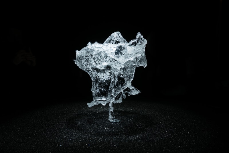 A round shower of water is frozen in mid air by strobe lighting.