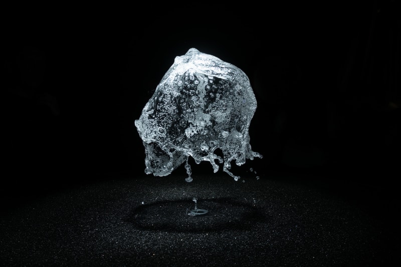A round shower of water is frozen in mid air by strobe lighting.