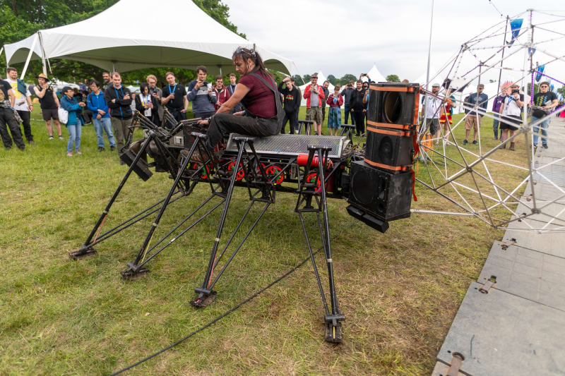 Person riding a giant mechanical robot with 8 legs