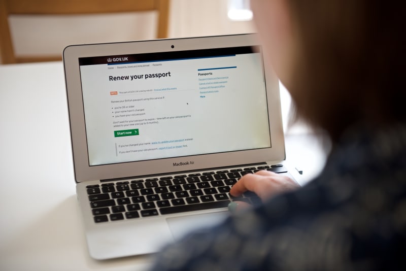 Photo of a woman using the new passport renewal service.