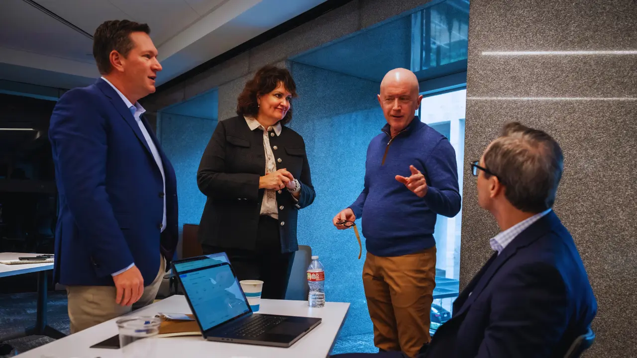 Four members of the T Bank SBA and commercial lending team actively engaged in a strategic discussion to help a client.