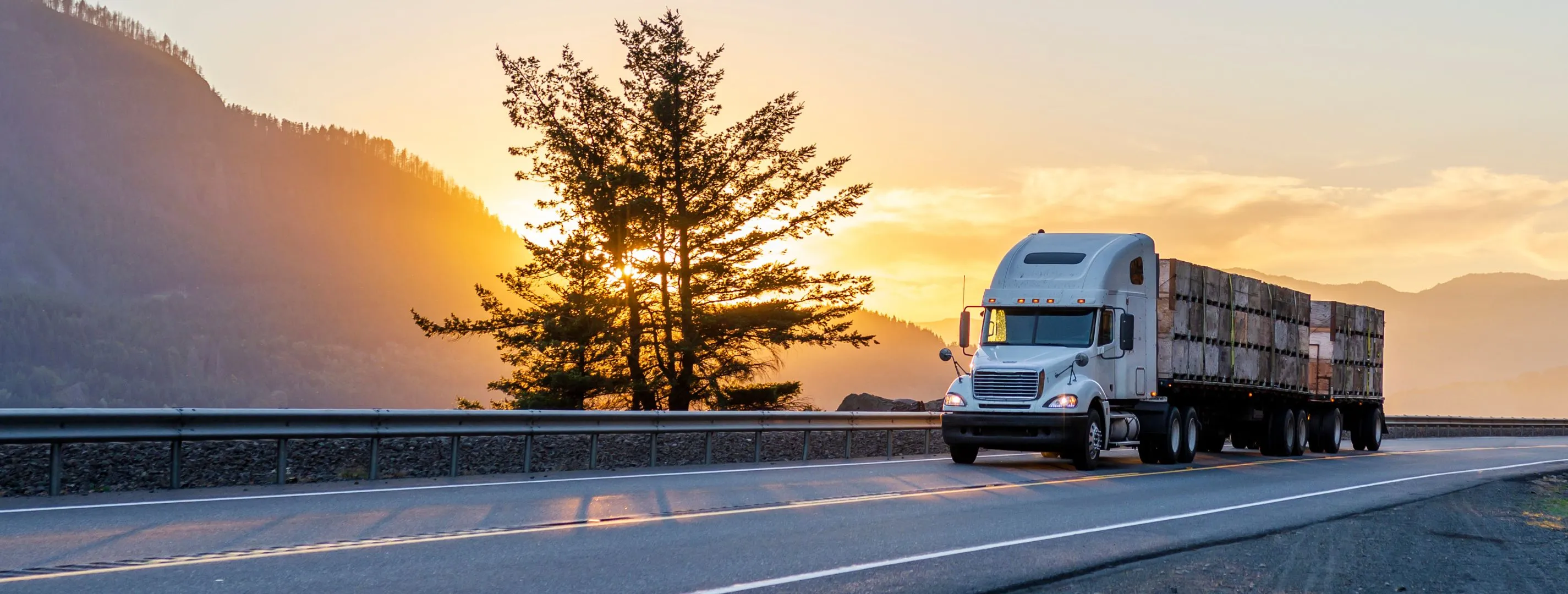 Two trucks running a mountain highway