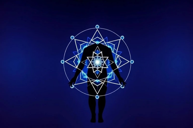 3D render of a human silhouette with glowing geometric chakra patterns