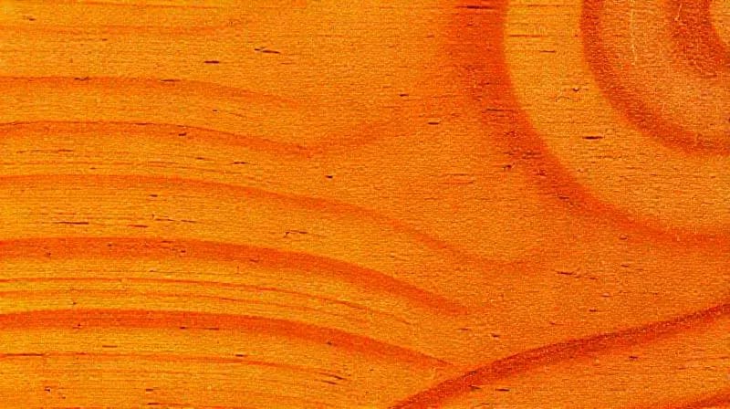 Primer plano de material biosostenible con pigmentos de color, mostrando la interacción de luz y textura.