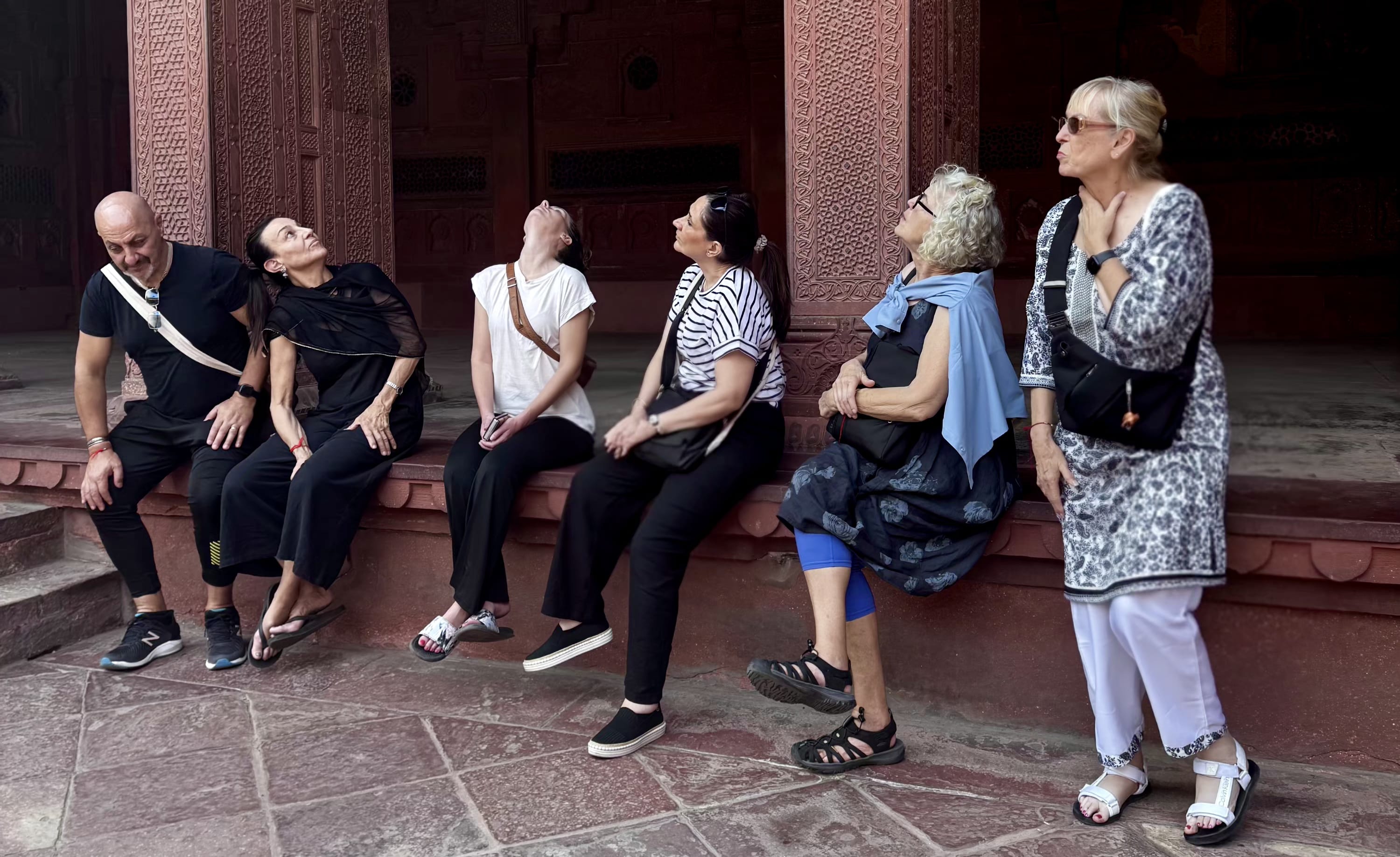 Travellers resting on the steps of a monument