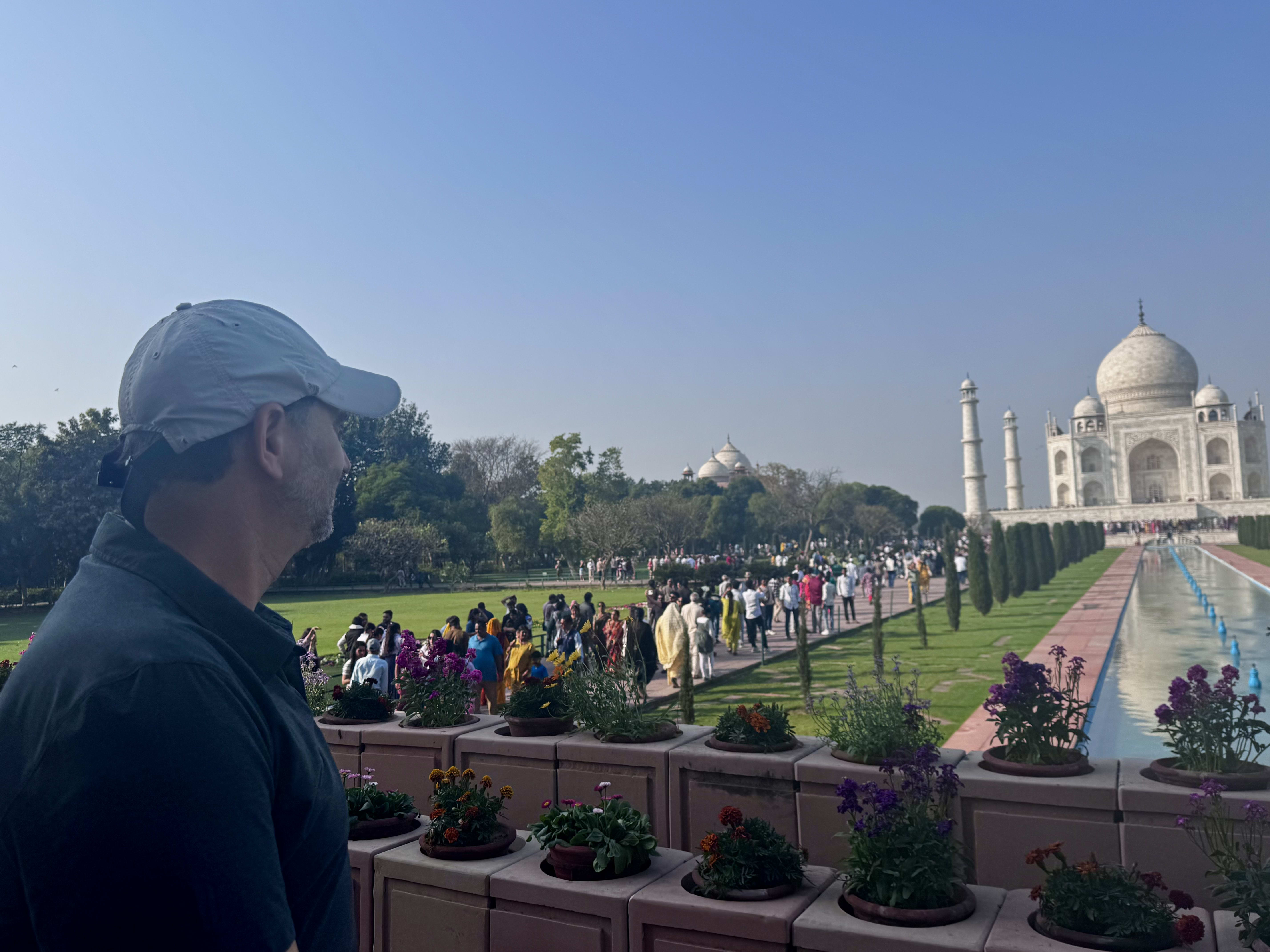 Visitors in the Taj Mahal gardens on a hazy morning