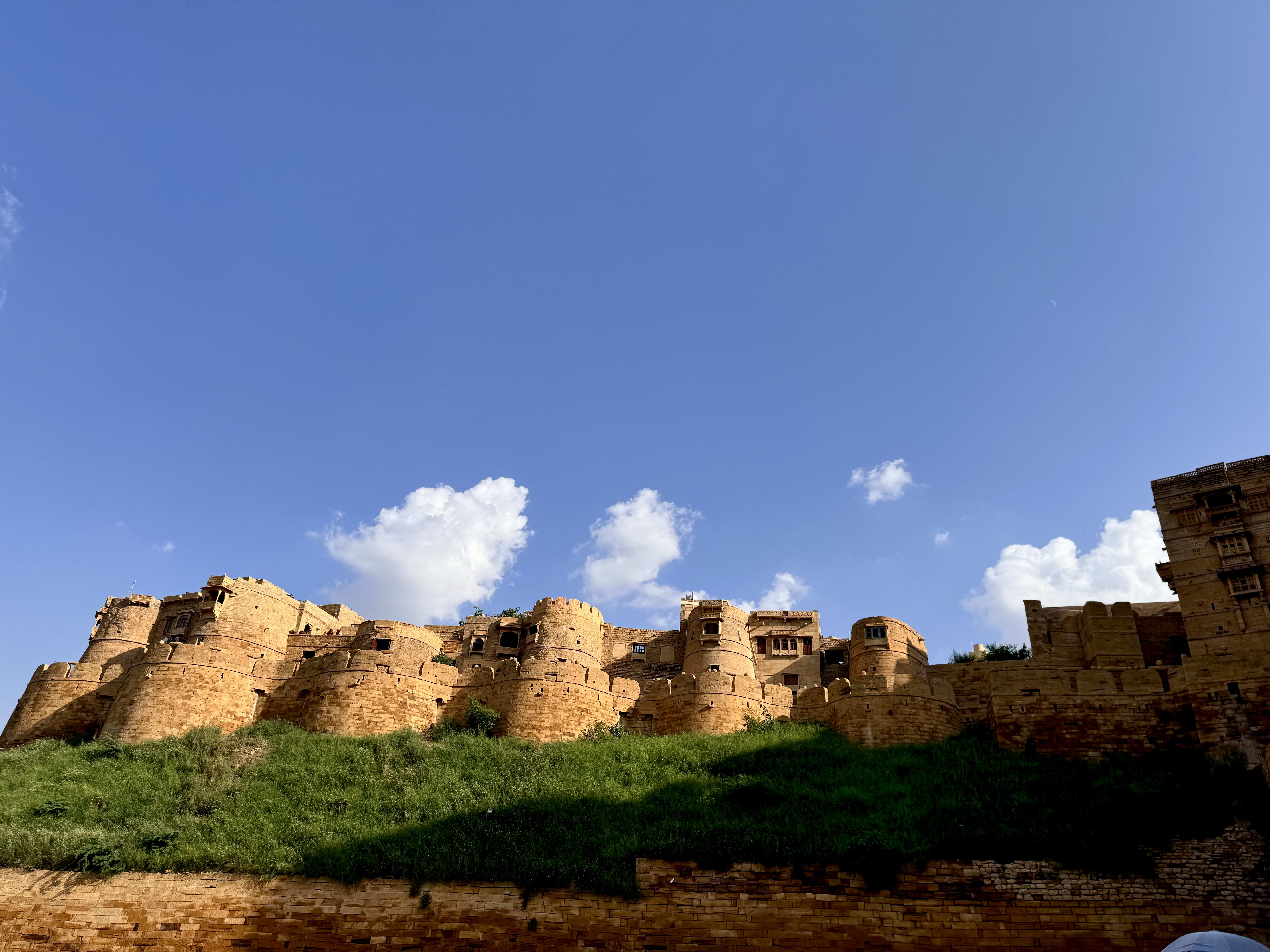 A ruined hilltop fort against a blue sky