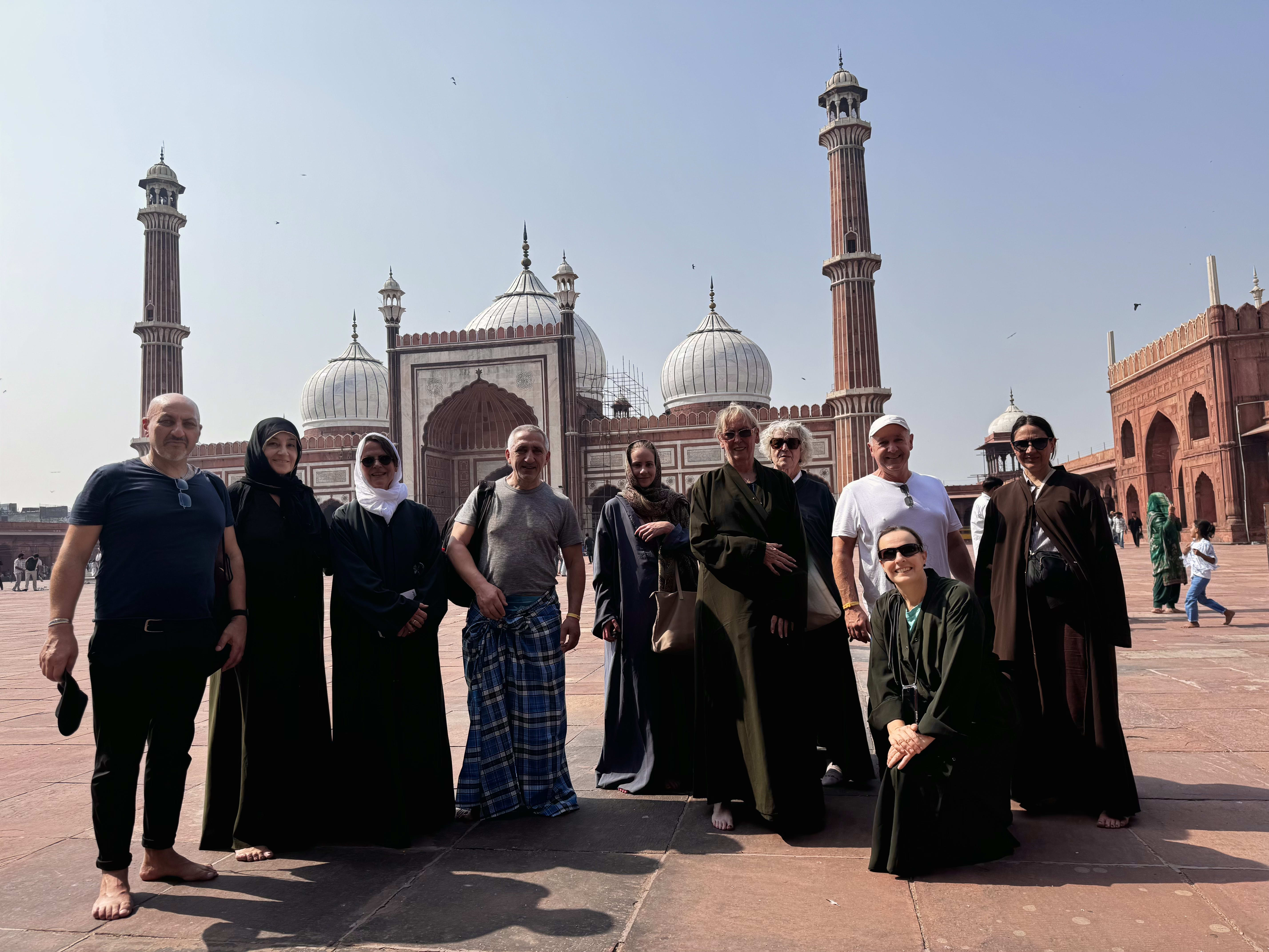 Travellers in robes in the courtyard of Jama Masjid, Delhi