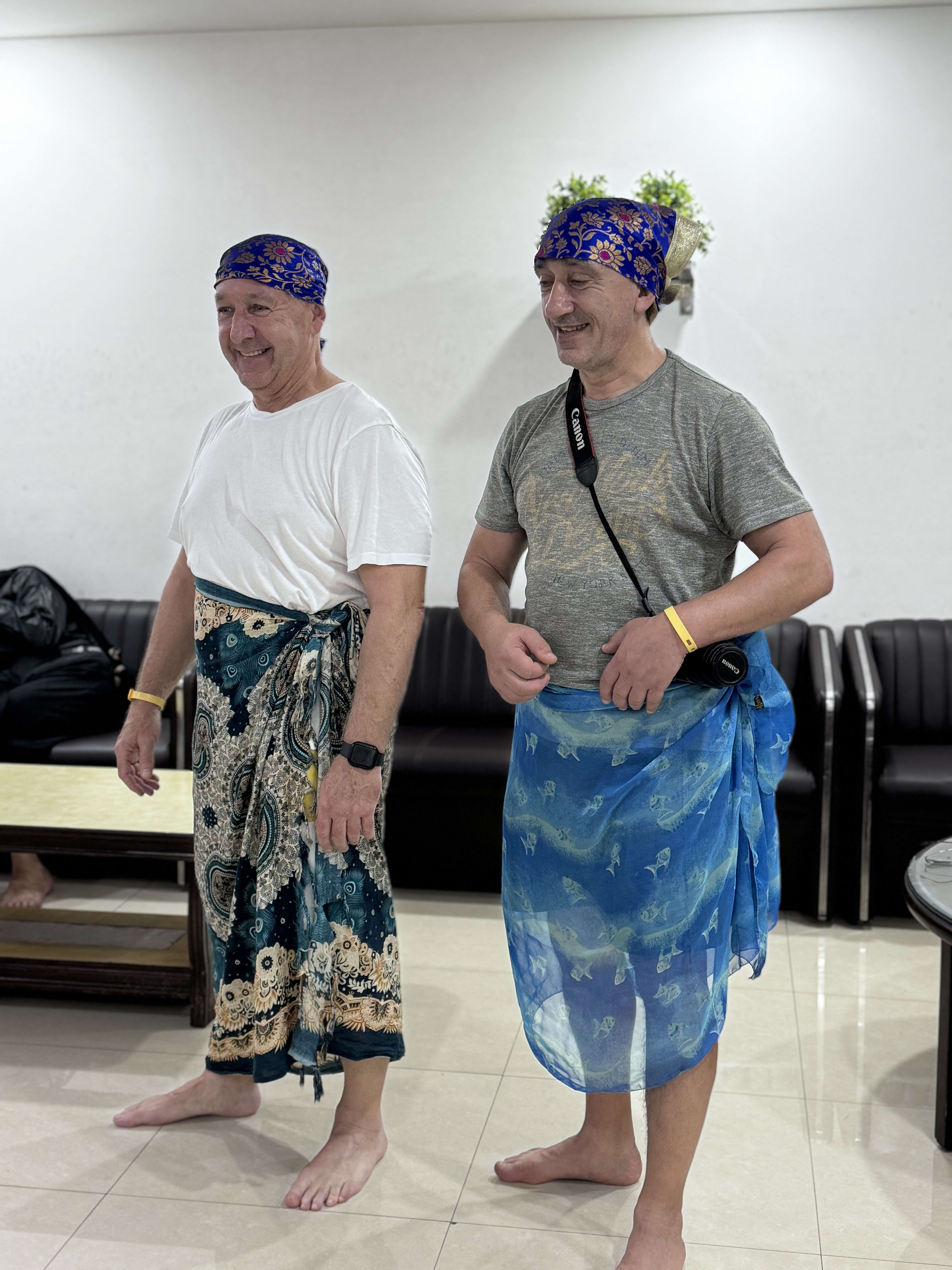 Two travellers trying on wrapped lungis