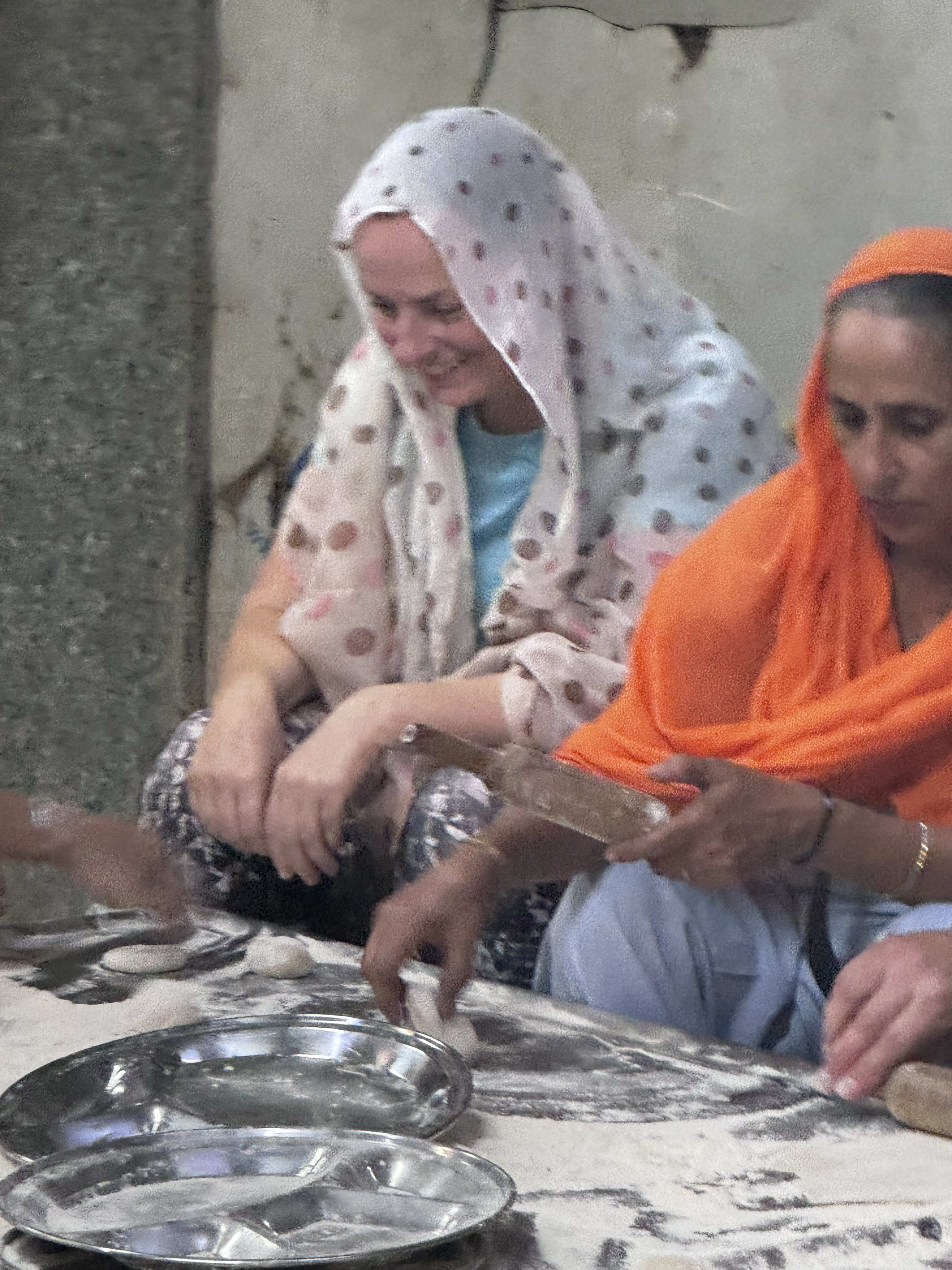 Henna being applied to a traveller's hands in an intricate mehndi pattern