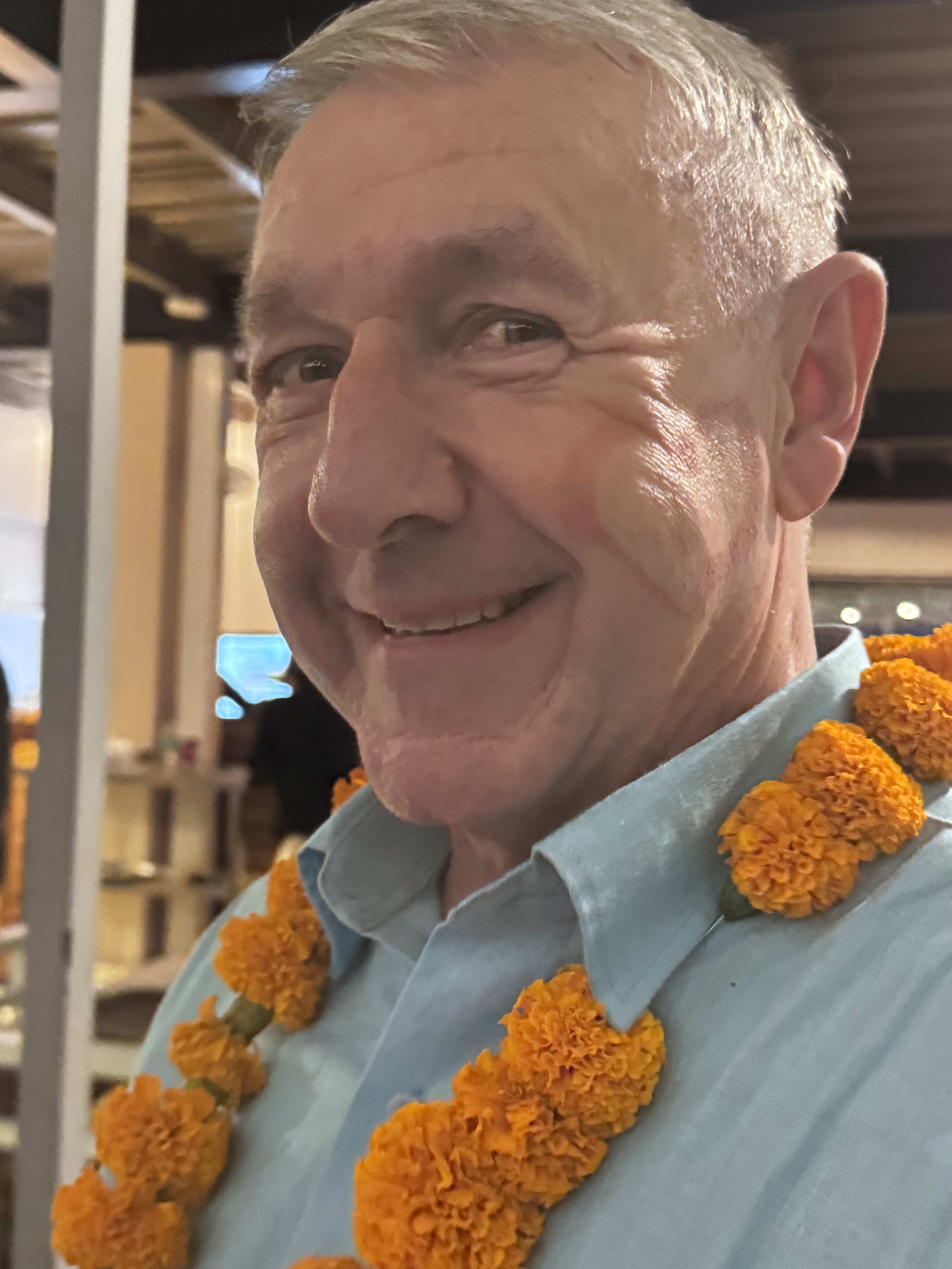 A traveller wearing marigold garlands