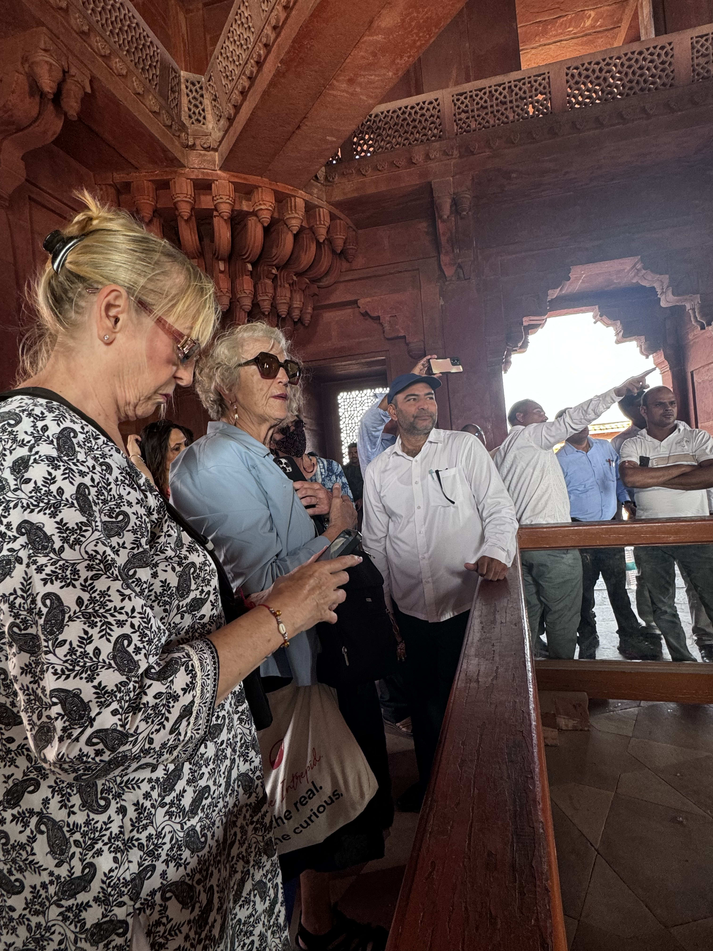 Older travellers listening to their guide at a monument