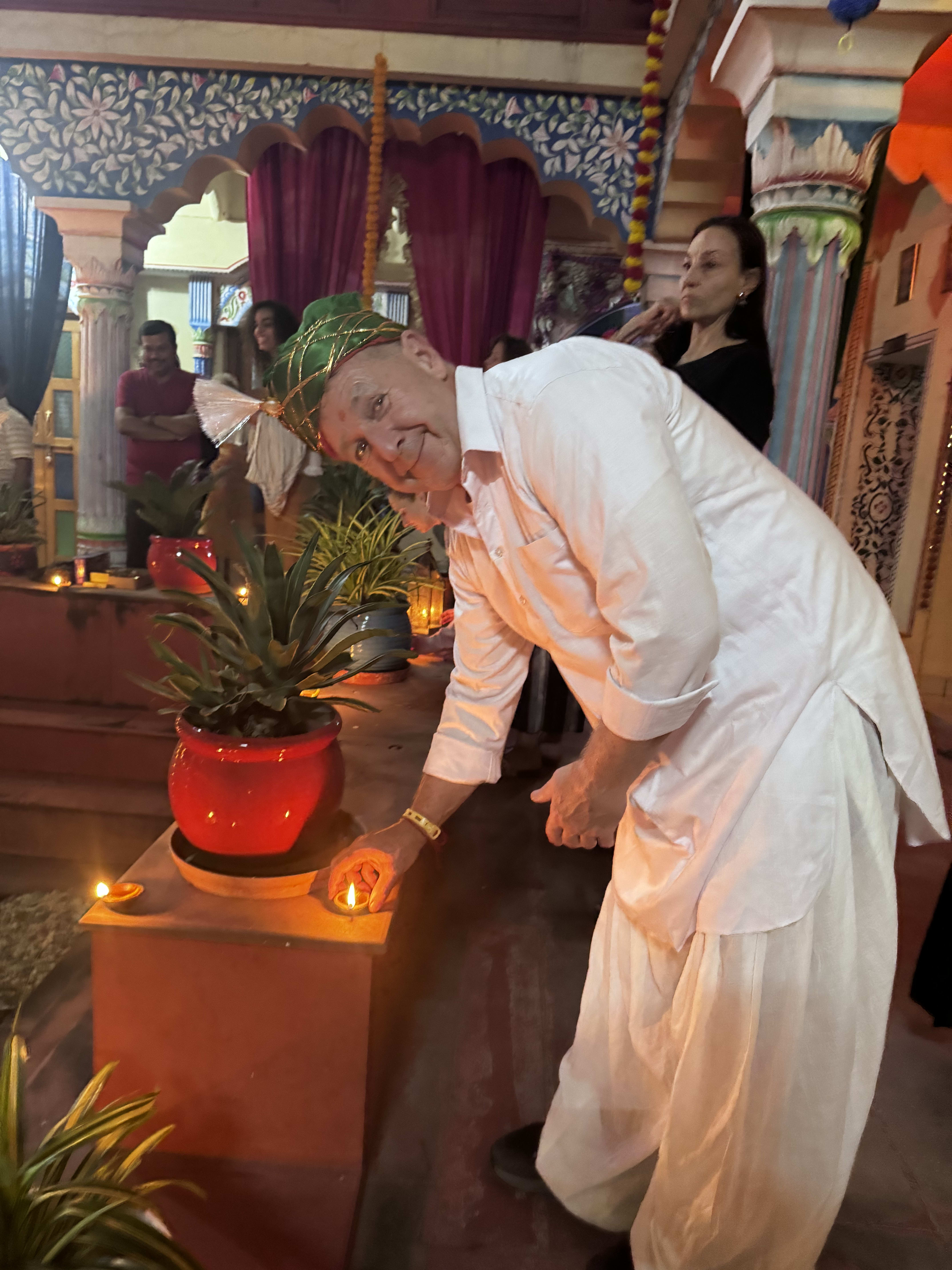 Oil lamps being lit for an evening arti ceremony