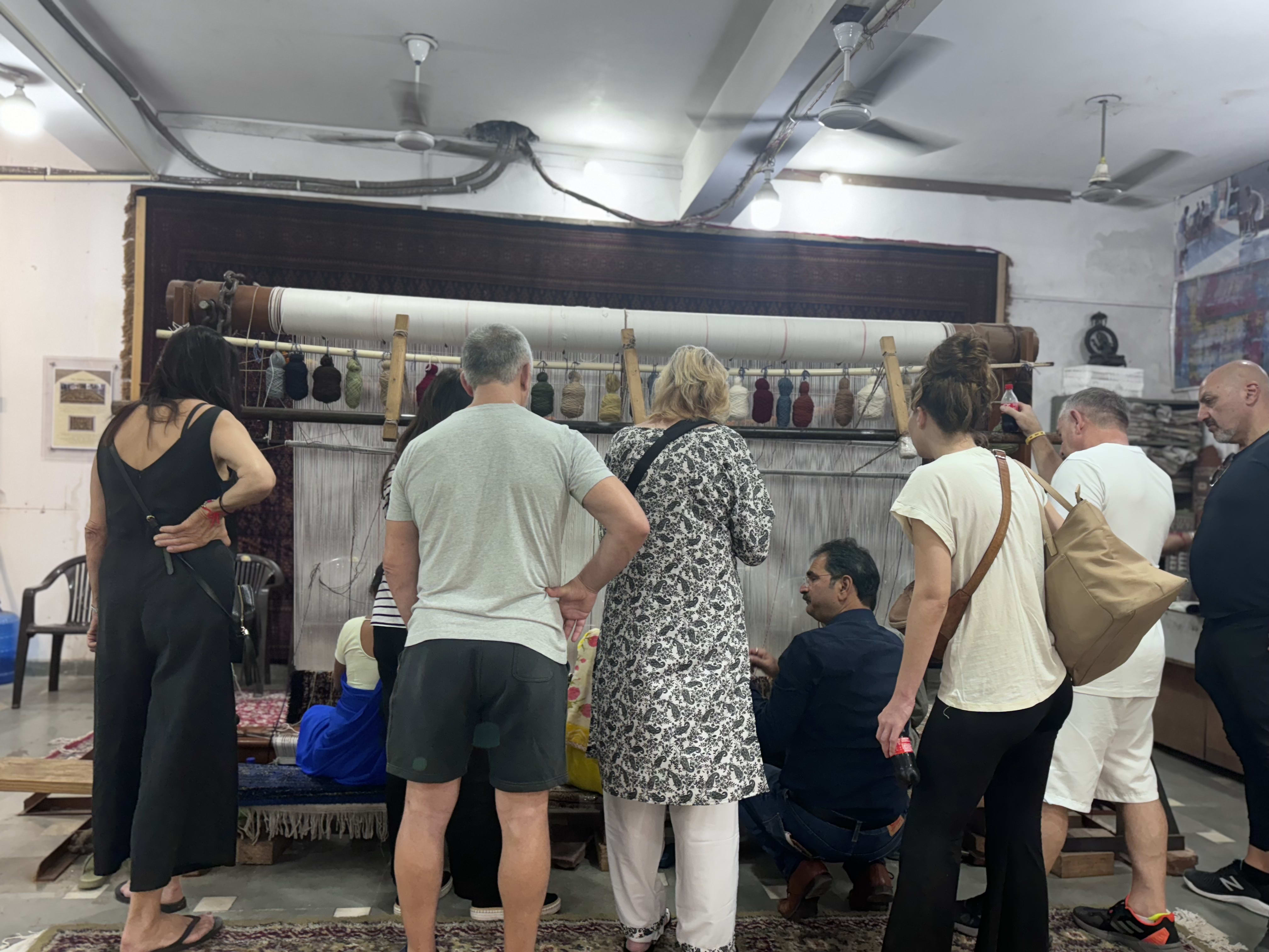 Travellers gathered inside a craft workshop