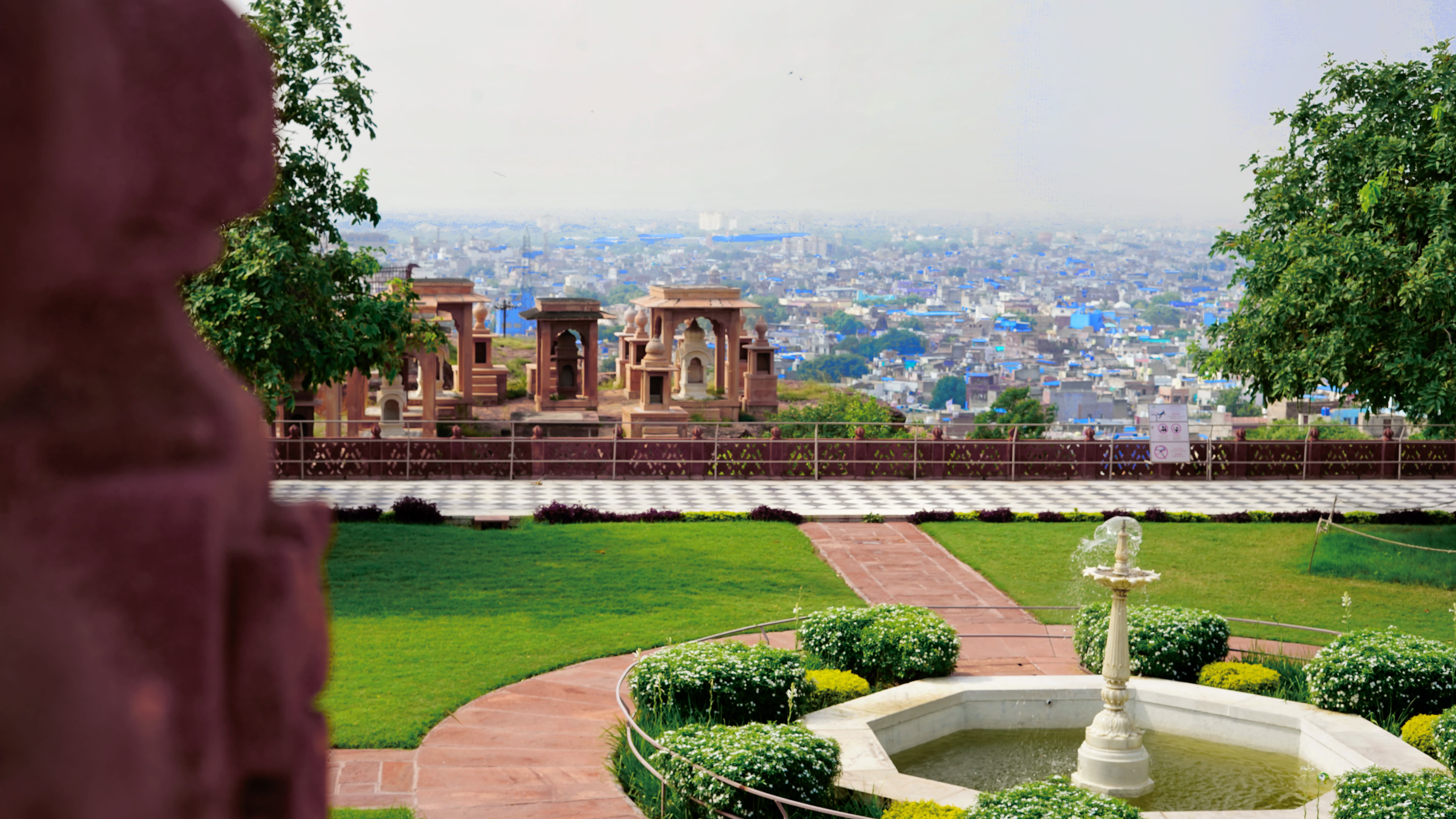 A heritage garden and fountain overlooking a Rajasthan city