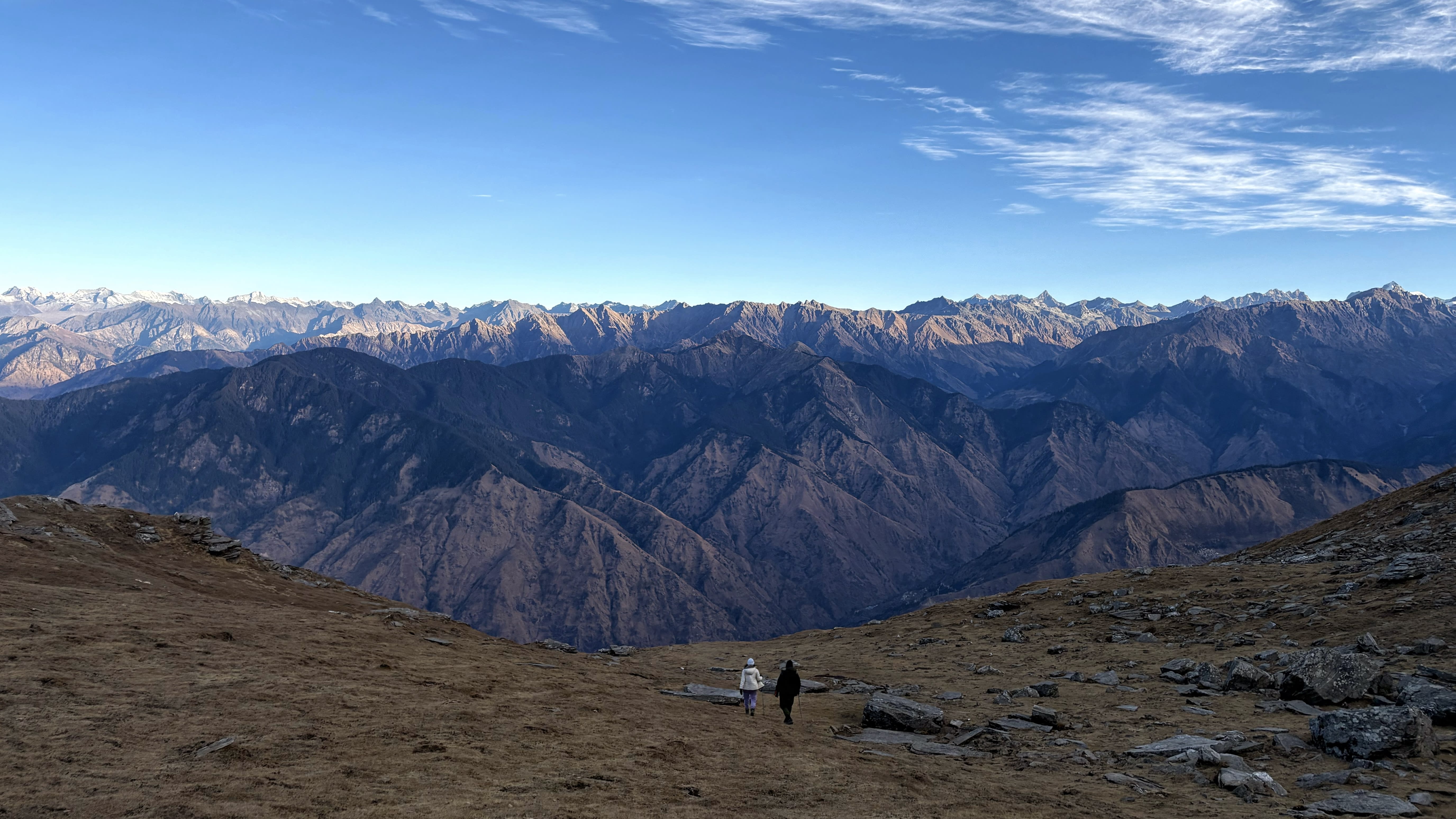 A walker dwarfed by the Himalayan ranges