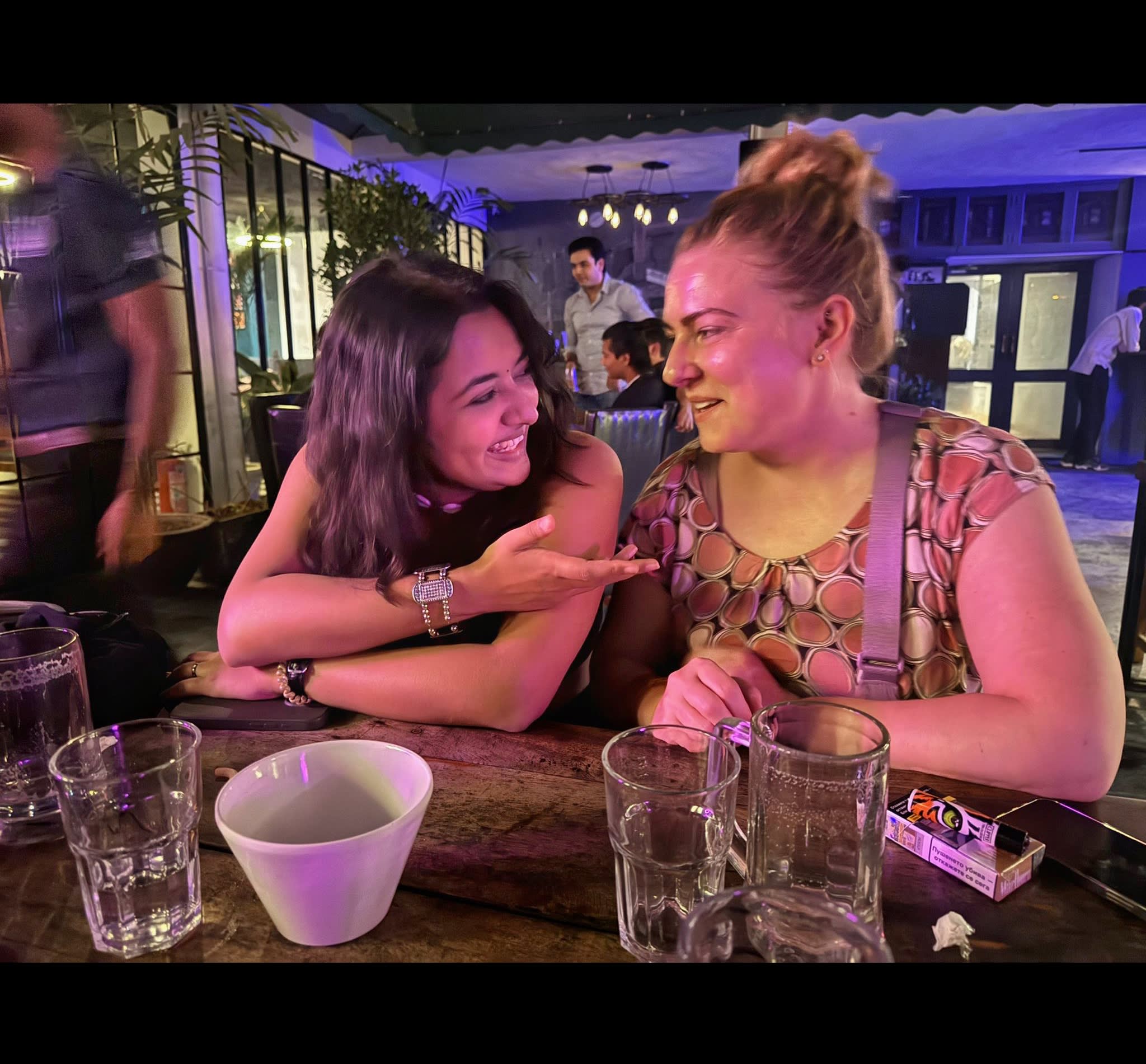 Travellers at a bar table in the evening