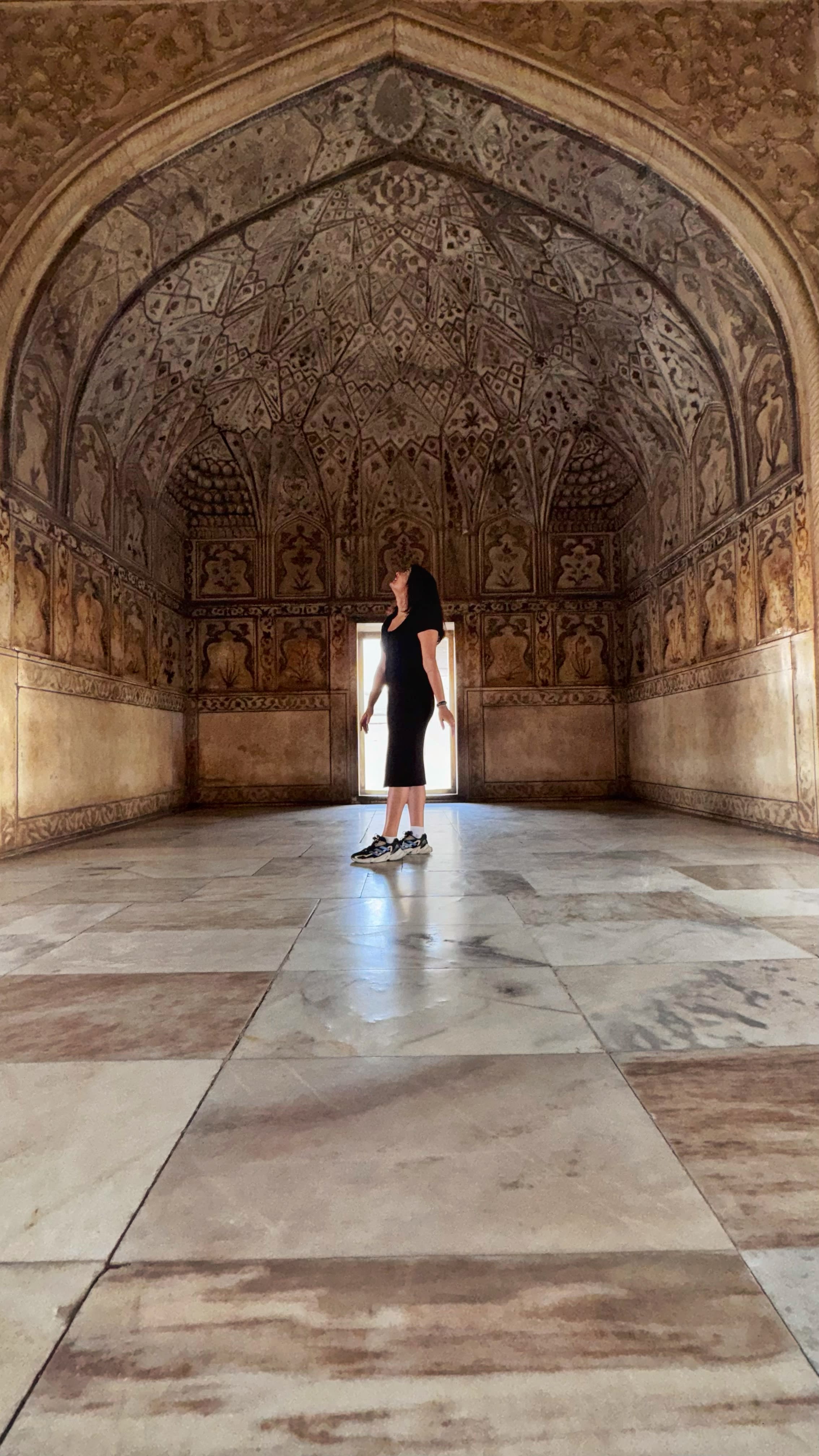 A visitor in a carved marble hall