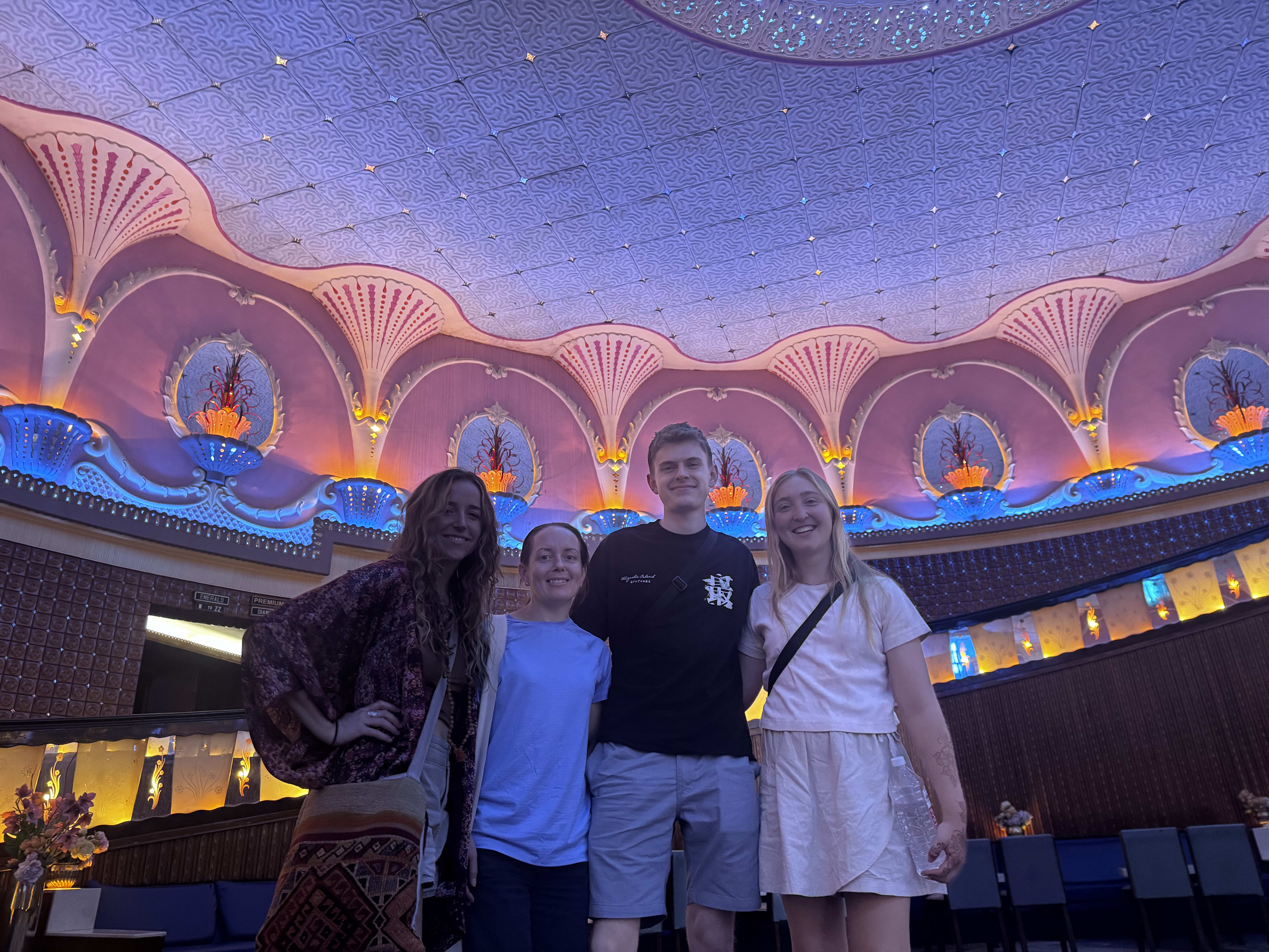 Travellers inside an ornate Indian cinema