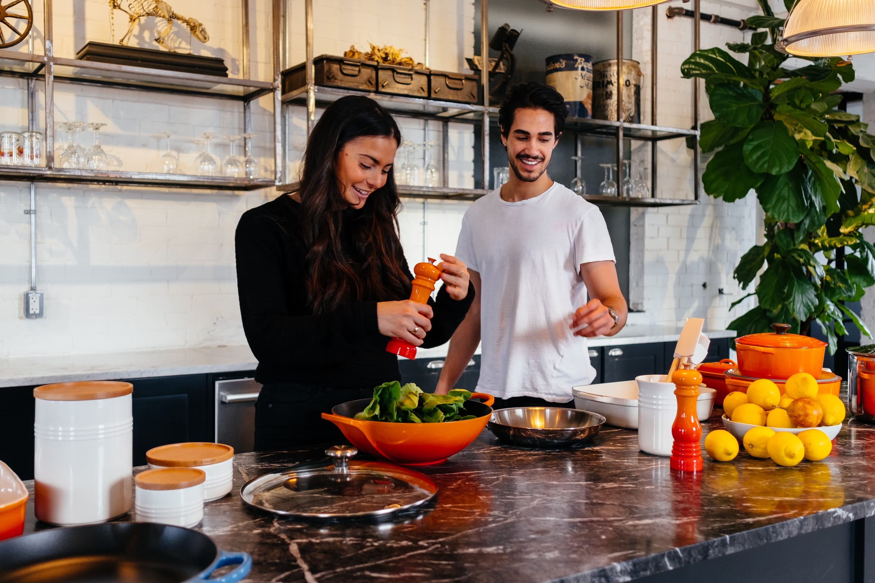 A couple in the kitchen cooking