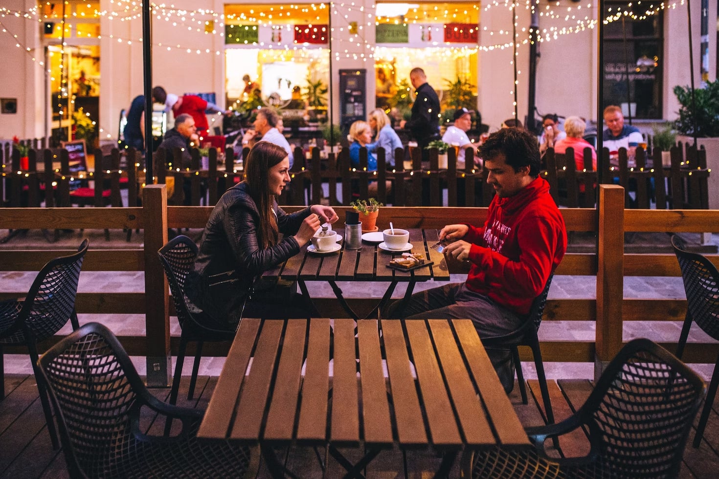 a woman and a man on a coffee date outside