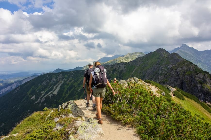 A couple hiking with hiking gear