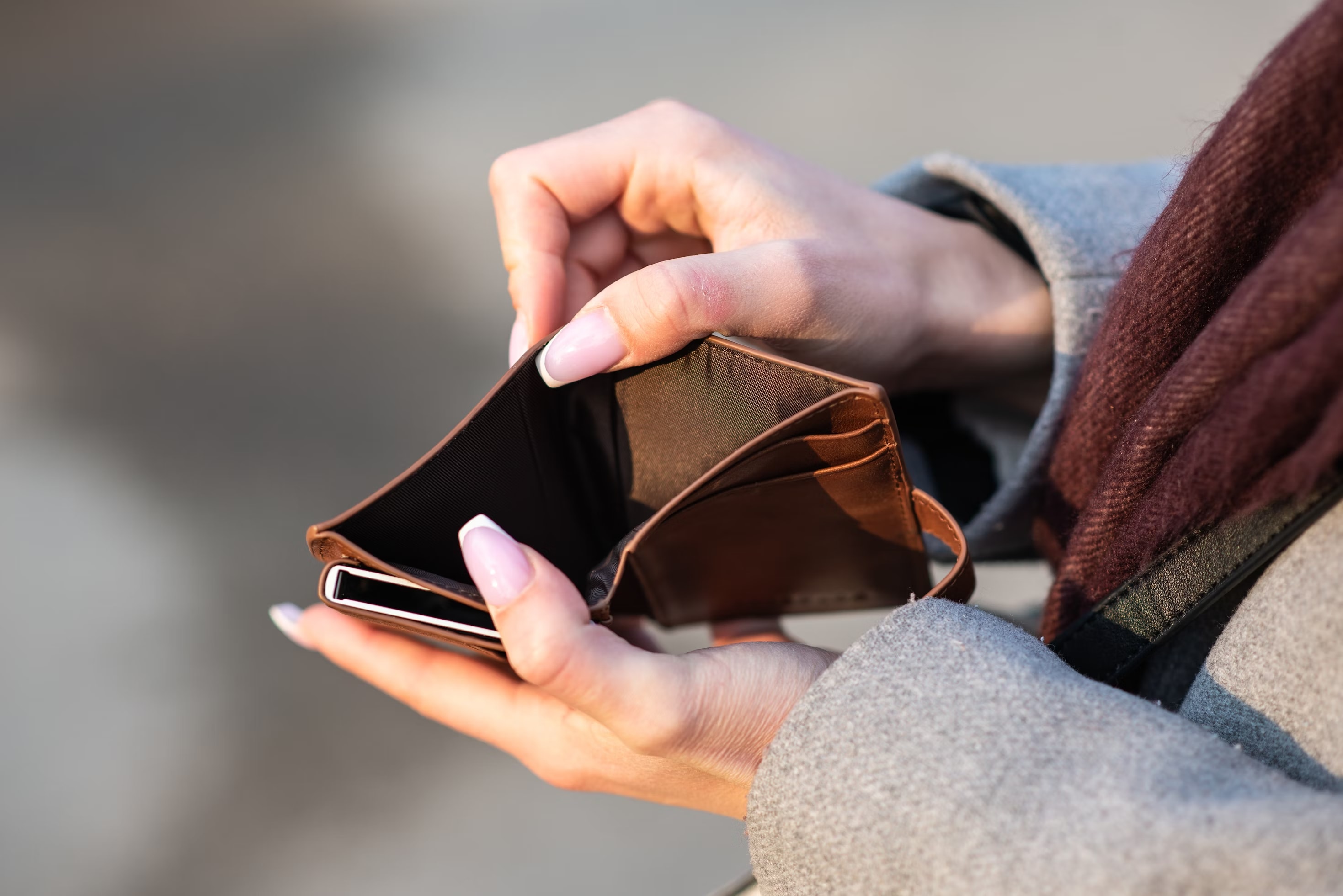 a woman holding an empty wallet