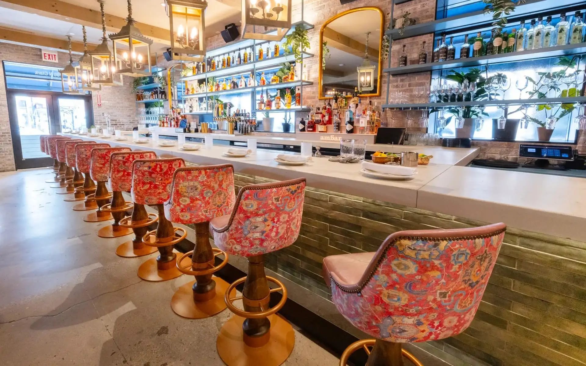 Diners on Ambar Chicago's flower-canopied patio
