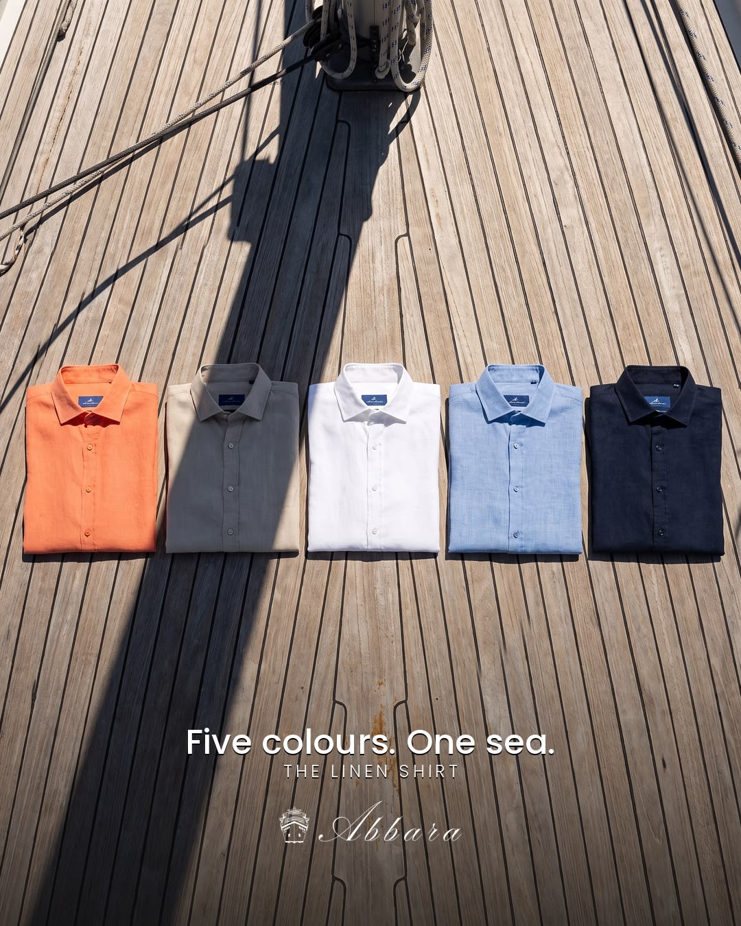 Five linen shirts arranged on a yacht deck