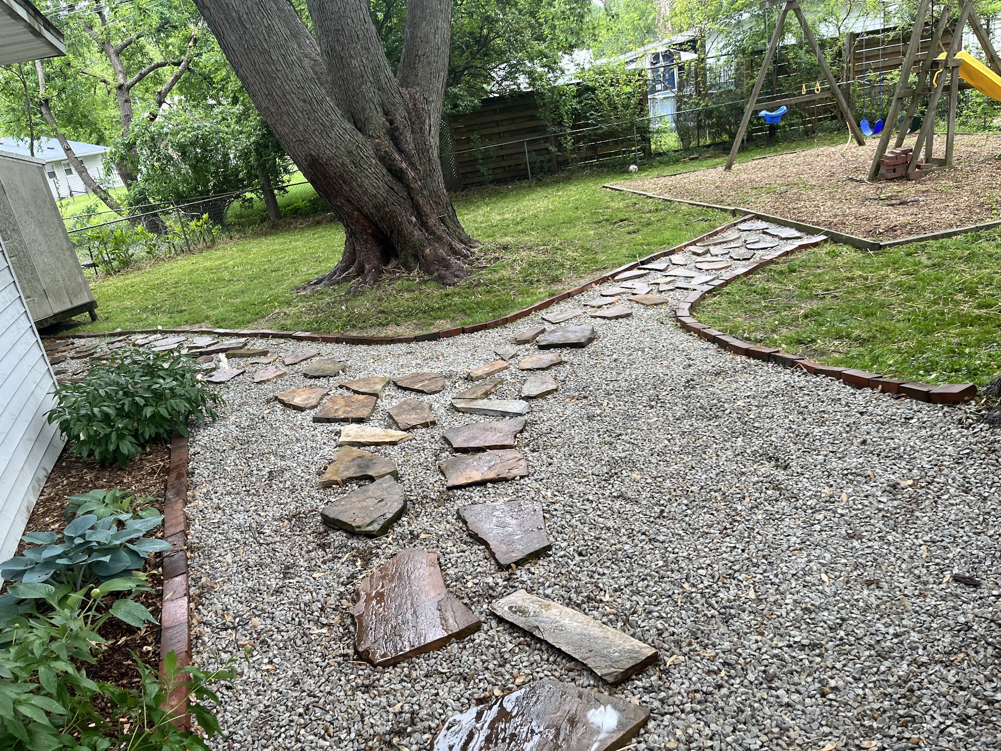Stepping stone path set into a mulched garden bed in Urbana, IL