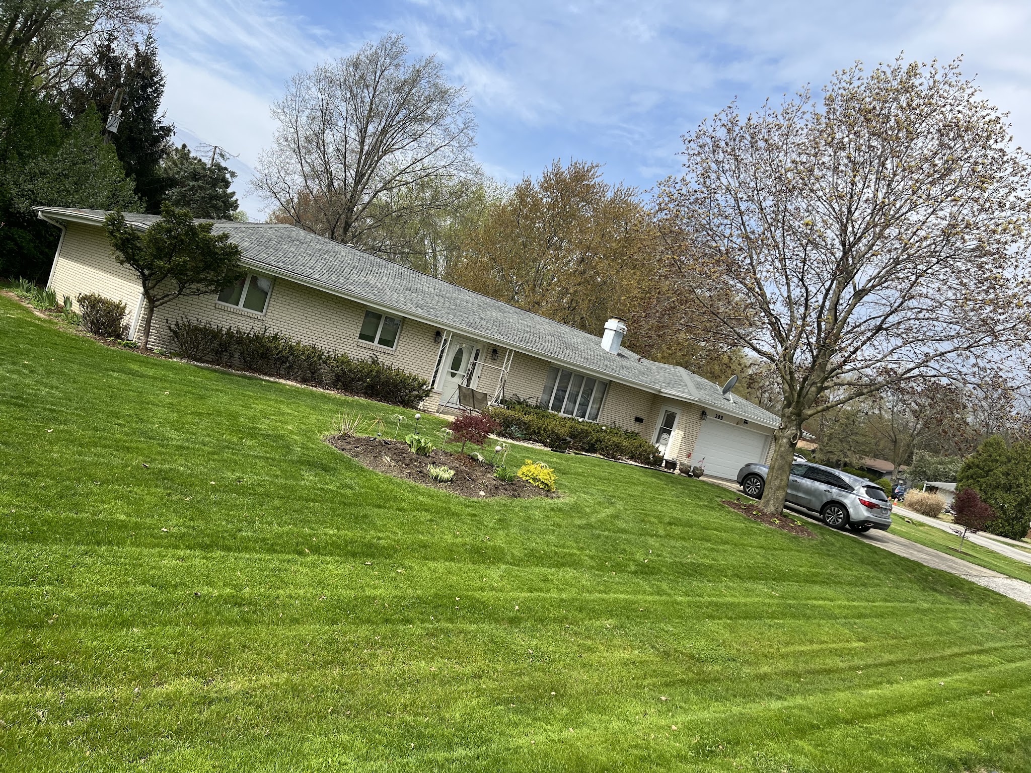 Freshly mowed and edged lawn maintained by M.A.D Landscape in Champaign-Urbana, IL