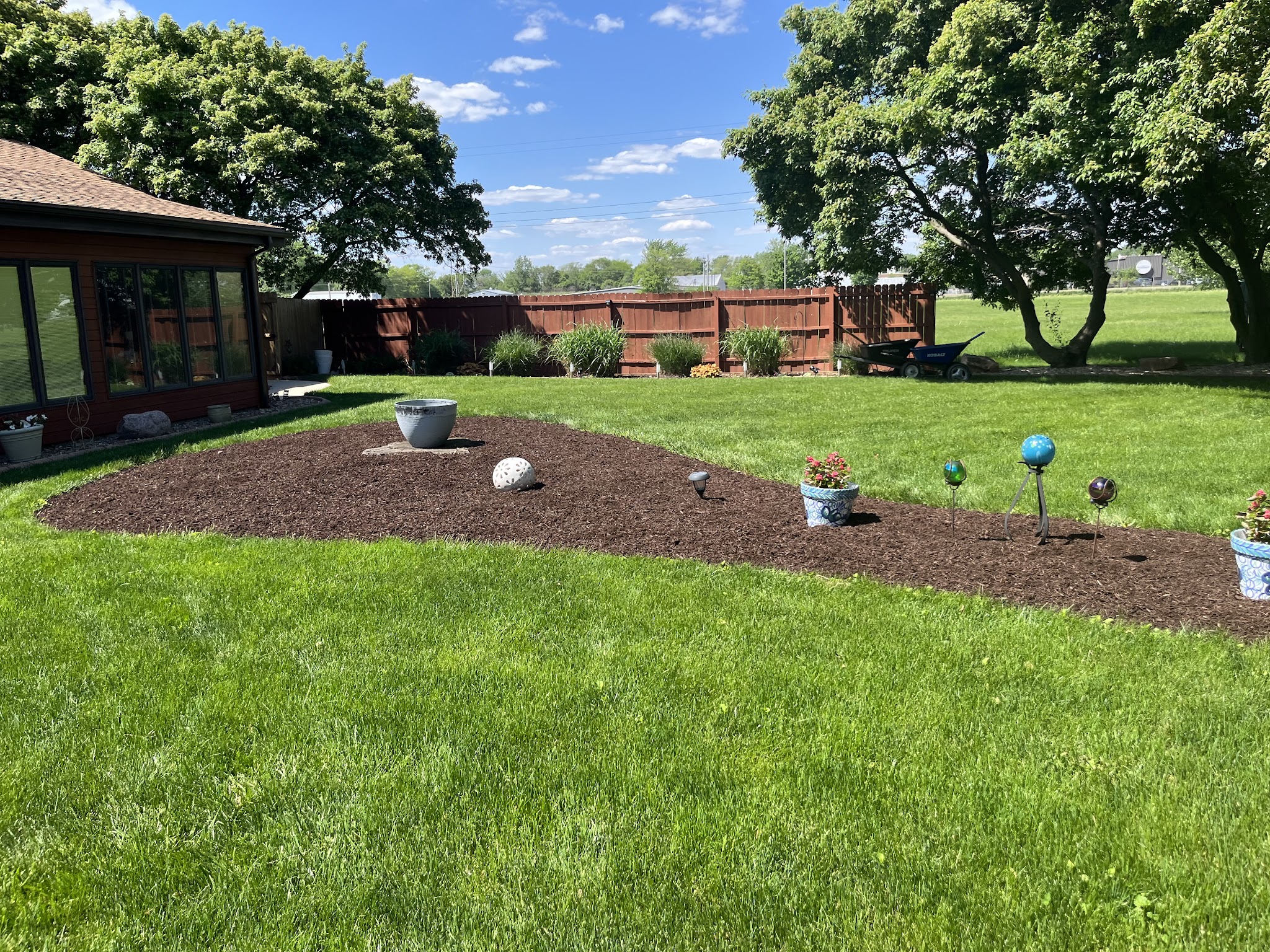 Maintained lawn and mulch beds at a brick property in Urbana, IL