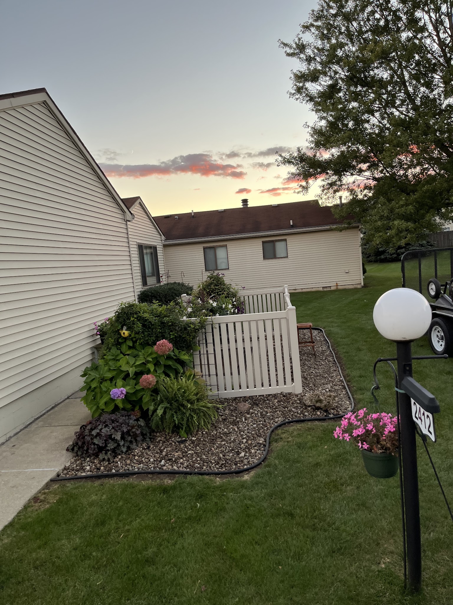 Tidy lawn and corner planting bed beside a home in Champaign-Urbana, IL