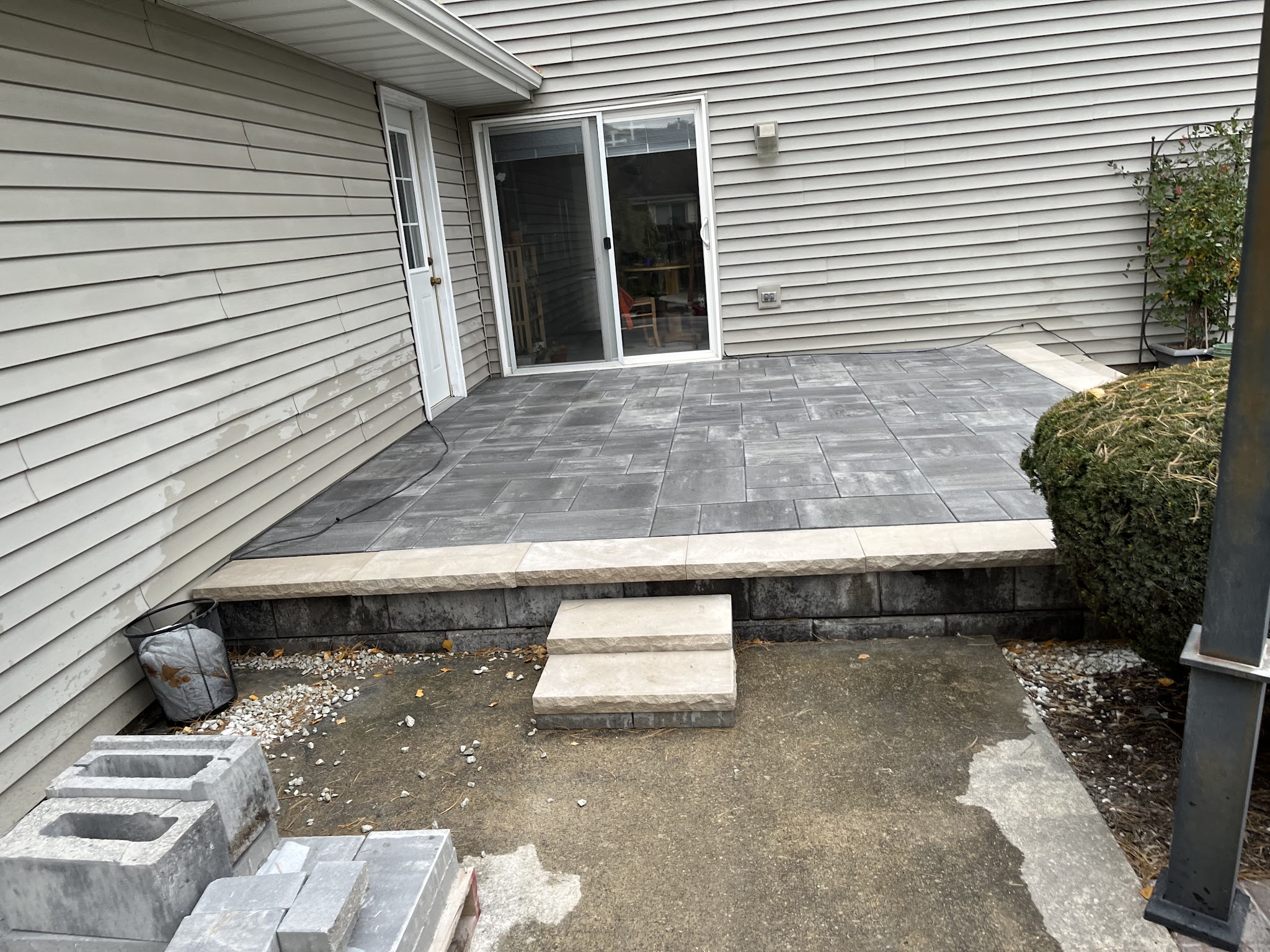 Poured concrete patio beside a home entrance in Champaign-Urbana, IL
