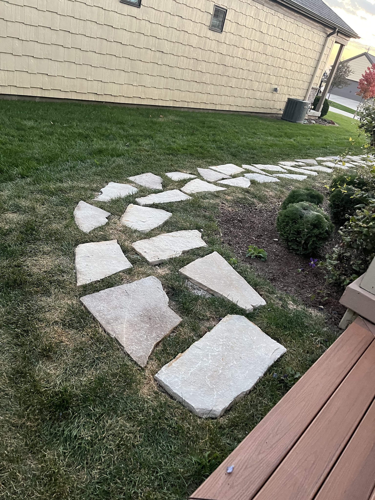 Flagstone stepping stones set into a lawn and garden in Champaign-Urbana, IL