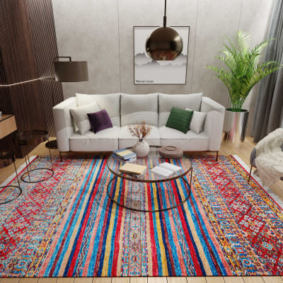 Mehreen Carpets Dubai Mall: Vibrant multicolor carpet in a modern living room with a gray sofa, glass table, and decor.