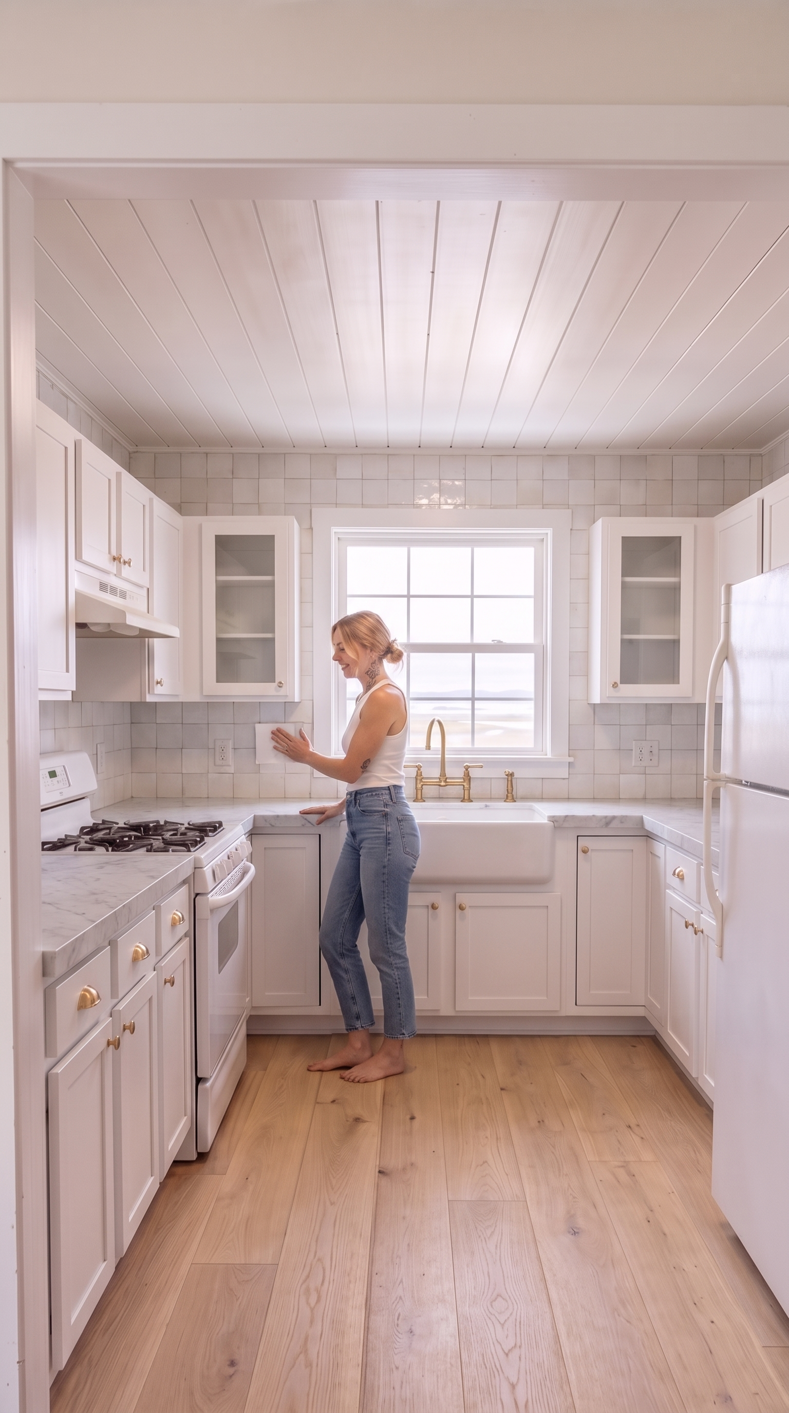 A glossy white handmade zellige tile backsplash extending full-height from the counters to the underside of the upper cabinets on all three walls, with subtle irregular gloss variation and straight stack-bond pattern