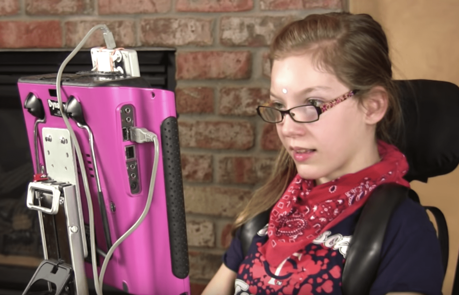 A head tracking device user wearing a reflective dot in front of their tracking camera