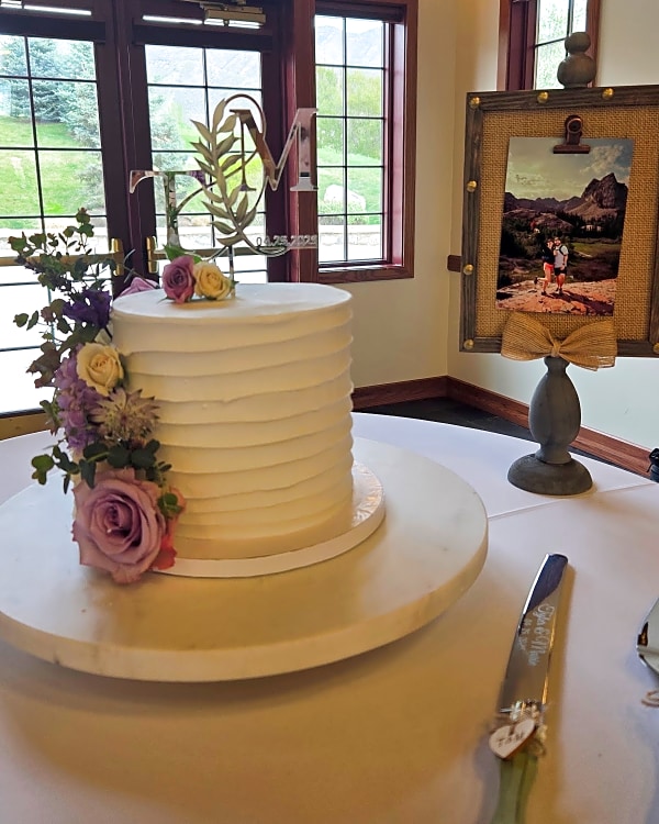 Single-tier ridged buttercream wedding cake with fresh flowers at This Is The Place Heritage Park