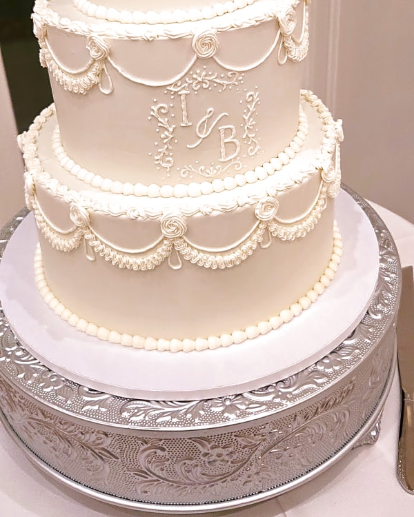 Twenty & Creek wedding cake, three-tier wedding cake with white buttercream, scalloped piping, and a monogram