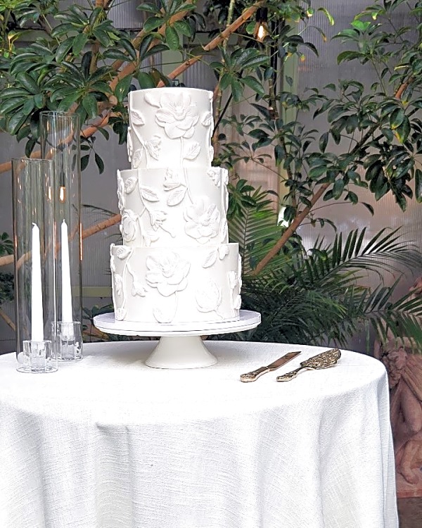 Wedding cake by Sweet E's Bakery in Sandy, three-tier round white cake with white buttercream floral bas-relief