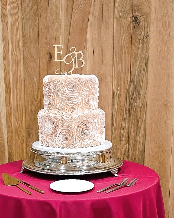 Blush buttercream rosette two-tier cake with a gold initials topper at Snowpine Lodge, Alta