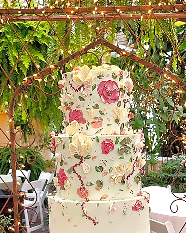 Wedding cake by Sweet E's Bakery in Sandy, three tier wedding cake with a pale green finish and delicate floral piping in shades of pink