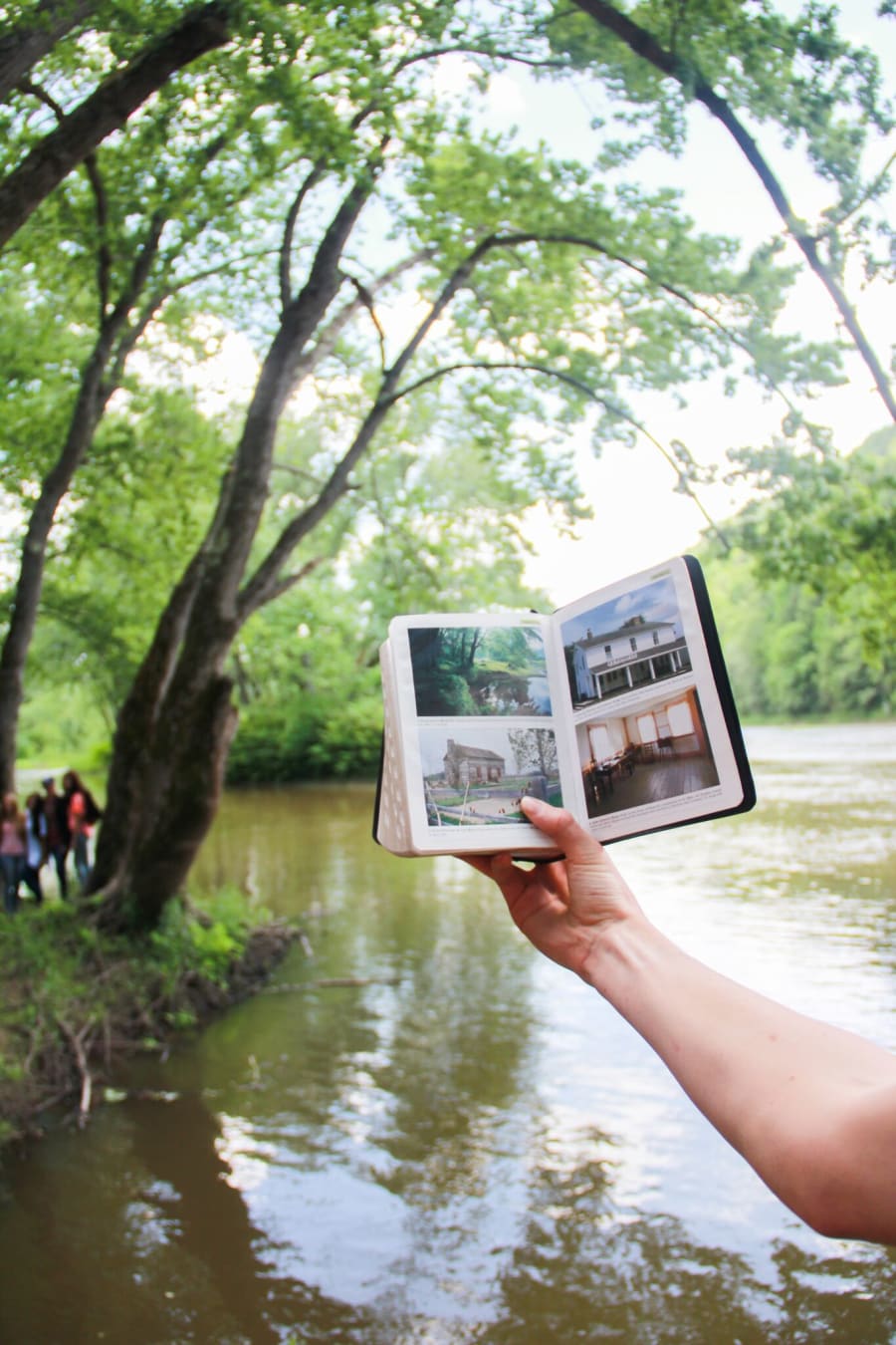 Students studying near a river