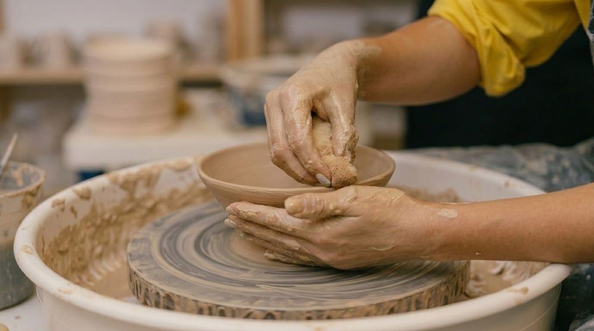 Quiet studio image supporting a ceramic and sound-based hands-on experience centered on clay and form.