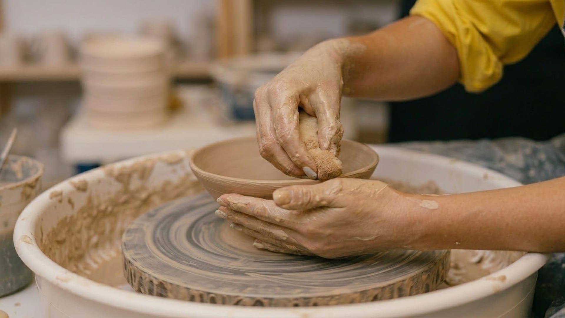 Quiet studio image supporting a ceramic and sound-based hands-on experience centered on clay and form.